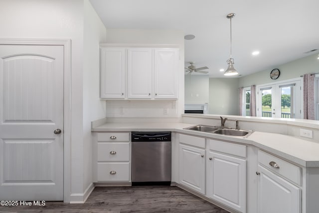 kitchen featuring white cabinets, a sink, a ceiling fan, wood finished floors, and stainless steel dishwasher