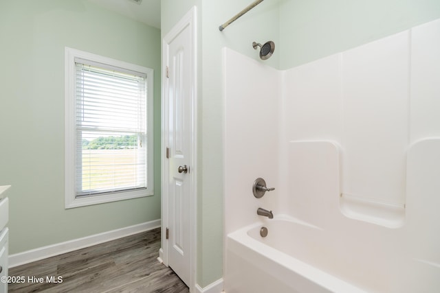 full bathroom featuring baseboards, shower / bathtub combination, and wood finished floors