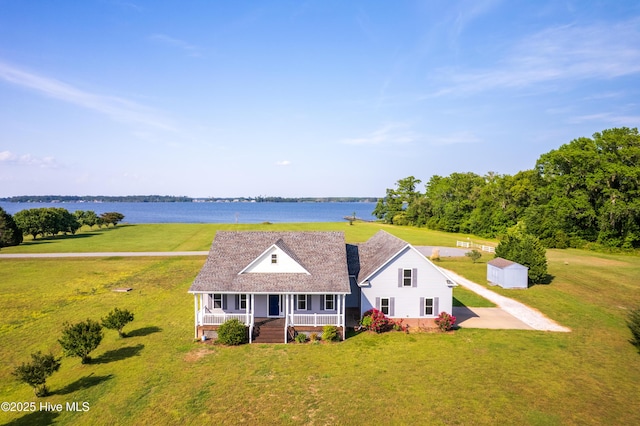 view of front of house with a porch, a water view, and a front yard
