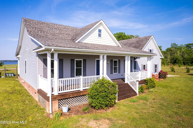 view of front of home with covered porch, a shingled roof, crawl space, and a front yard