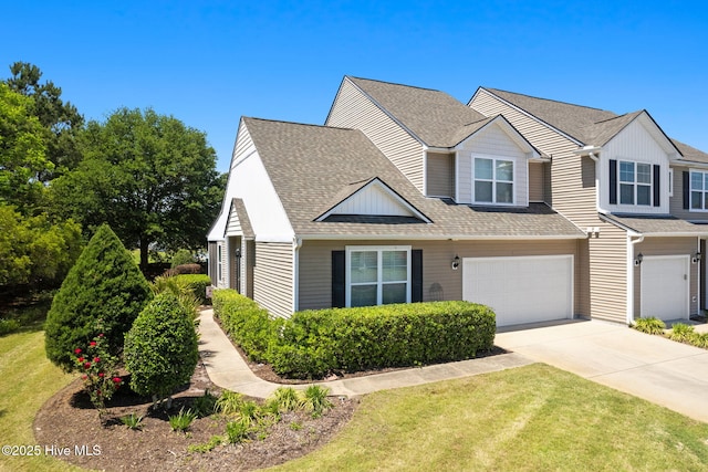 view of front of house featuring driveway, an attached garage, a shingled roof, and a front lawn