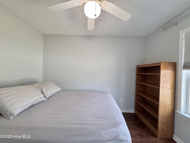 212 Red Carnation Dr, Holly Ridge, NC 28445 - bedroom with wood finished floors, baseboards, and a ceiling fan