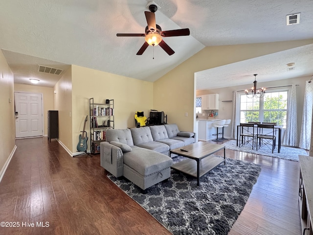 212 Red Carnation Dr, Holly Ridge, NC 28445 - living room featuring wood finished floors, a textured ceiling, vaulted ceiling, ceiling fan, and a chandelier