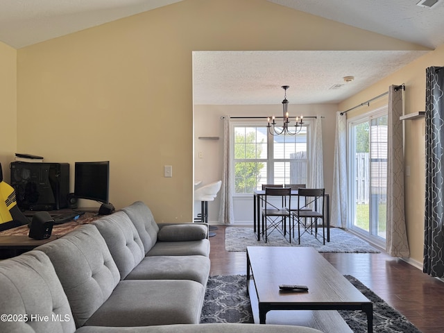 212 Red Carnation Dr, Holly Ridge, NC 28445 - living area with vaulted ceiling, a chandelier, dark wood-type flooring, baseboards, and a textured ceiling