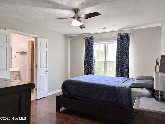 212 Red Carnation Dr, Holly Ridge, NC 28445 - bedroom with dark wood finished floors, a textured ceiling, baseboards, and a ceiling fan
