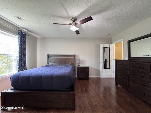 212 Red Carnation Dr, Holly Ridge, NC 28445 - bedroom with wood finished floors, a textured ceiling, baseboards, and a ceiling fan