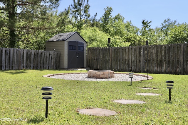 212 Red Carnation Dr, Holly Ridge, NC 28445 - view of yard featuring a fire pit, a storage unit, and an outdoor structure