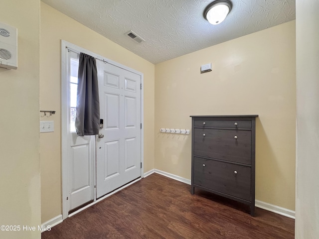 212 Red Carnation Dr, Holly Ridge, NC 28445 - entrance foyer with dark wood-type flooring, baseboards, and a textured ceiling