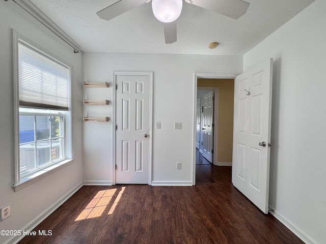 212 Red Carnation Dr, Holly Ridge, NC 28445 - unfurnished bedroom with wood finished floors, baseboards, ceiling fan, and a textured ceiling