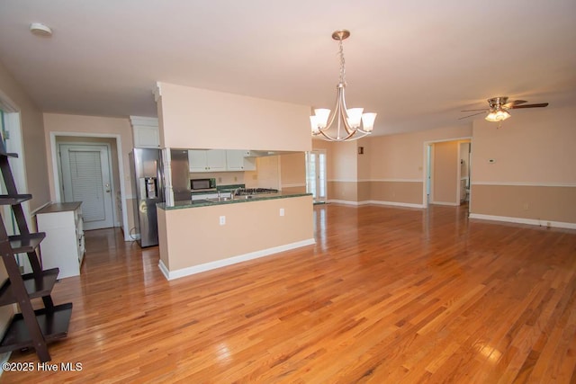 104 Stevens Ct, Swansboro, NC 28584 - kitchen with dark countertops, appliances with stainless steel finishes, white cabinets, and light wood-type flooring