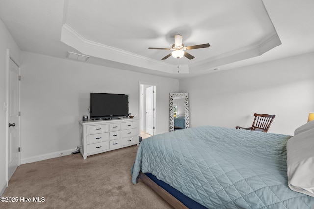 bedroom with ornamental molding, carpet, visible vents, a tray ceiling, and baseboards
