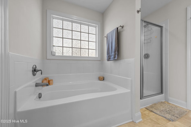 full bath with tile patterned floors, a garden tub, and a stall shower