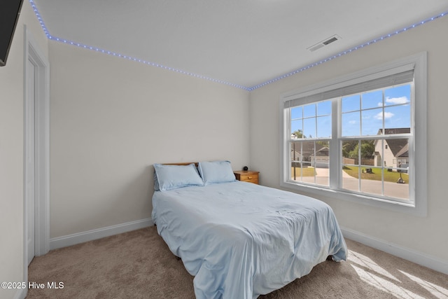 bedroom featuring carpet flooring, visible vents, and baseboards