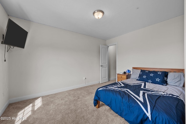carpeted bedroom featuring baseboards