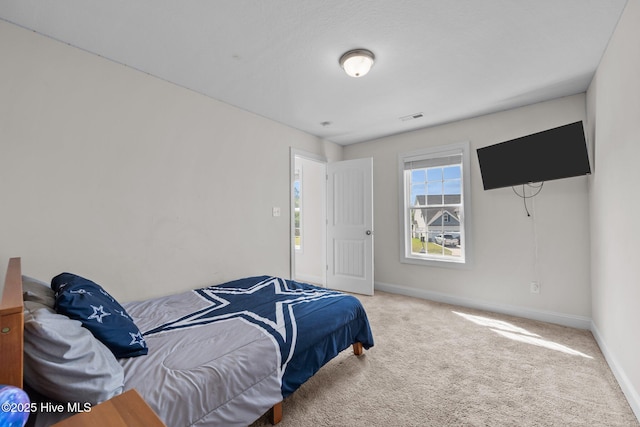 bedroom with carpet floors, baseboards, and visible vents