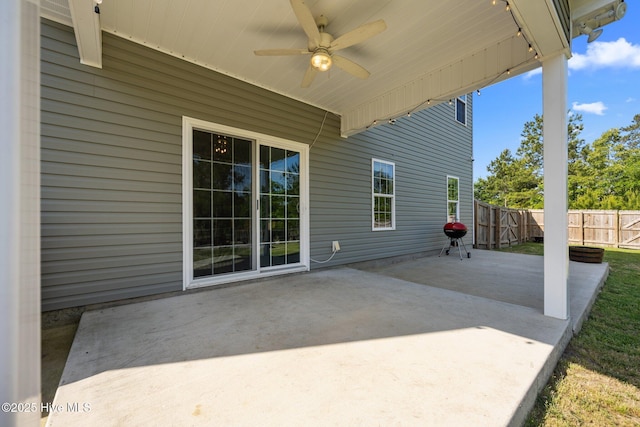 view of patio / terrace with fence and a ceiling fan