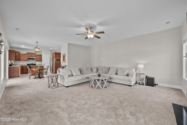 living room with light carpet, baseboards, a ceiling fan, and visible vents