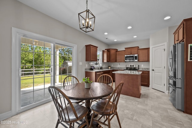 dining space with baseboards, a notable chandelier, and recessed lighting