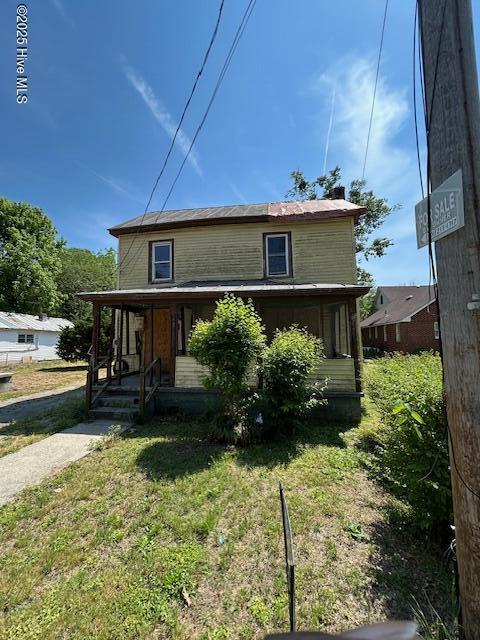 view of front of property with a porch and a front yard