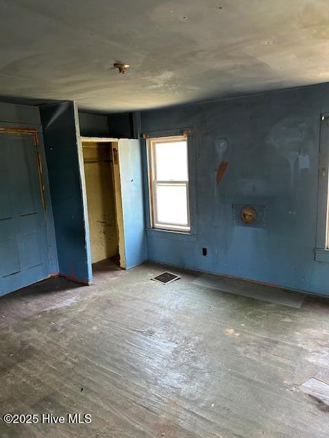 unfurnished bedroom with visible vents