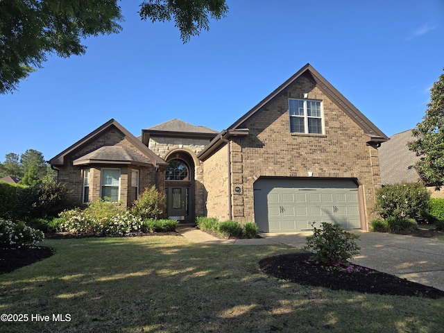 view of front of home with an attached garage, stone siding, brick siding, a front yard, and concrete driveway