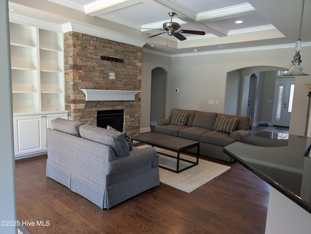living area featuring crown molding and arched walkways
