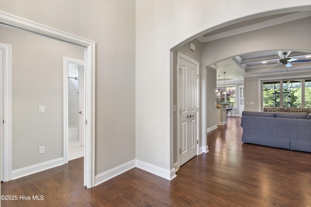 6618 Motts Village Rd, Wilmington, NC 28412 - hallway featuring wood finished floors, crown molding, arched walkways, coffered ceiling, and baseboards