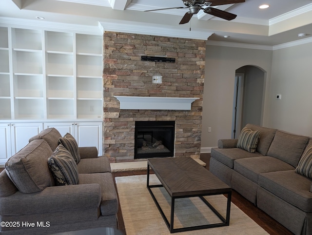living room featuring a ceiling fan, crown molding, arched walkways, wood finished floors, and recessed lighting
