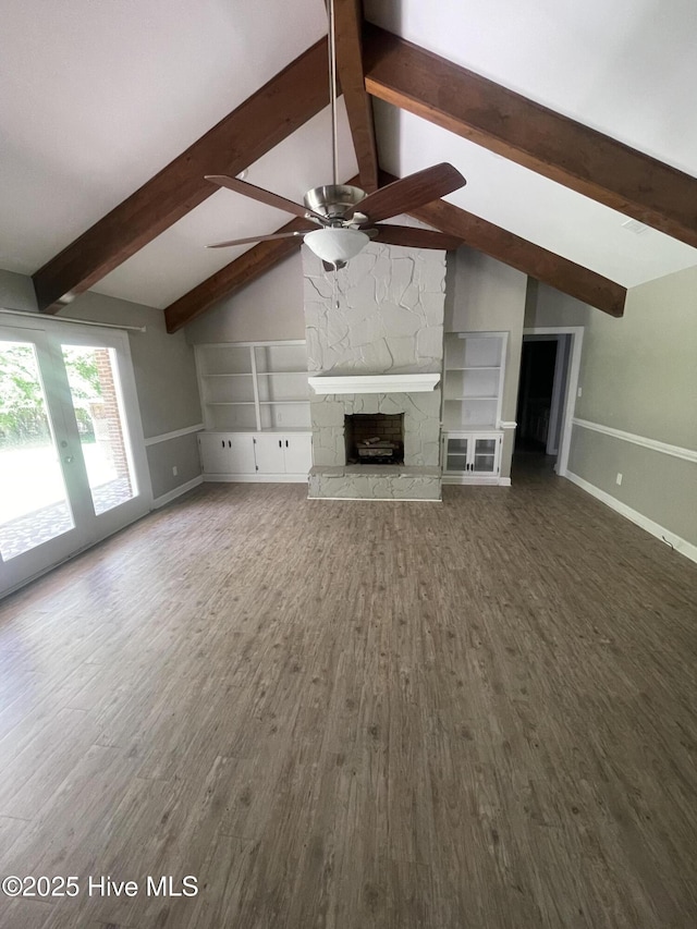 unfurnished living room with baseboards, a ceiling fan, lofted ceiling with beams, and wood finished floors