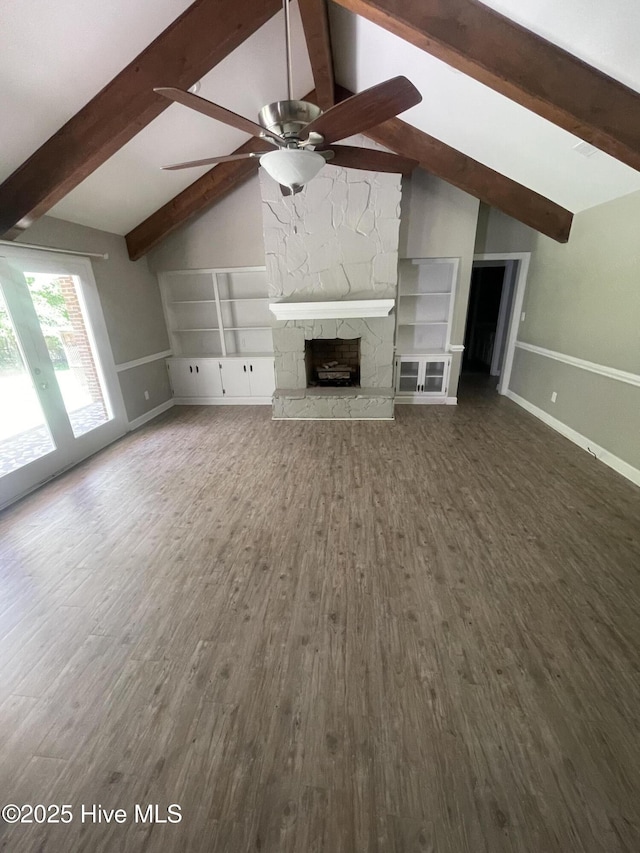 unfurnished living room with baseboards, ceiling fan, lofted ceiling with beams, and wood finished floors