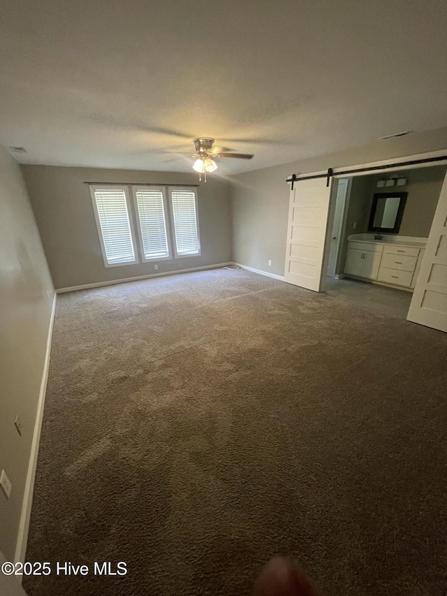 unfurnished room featuring baseboards, ceiling fan, and carpet flooring