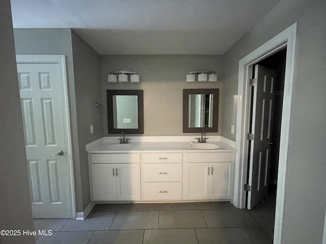 full bathroom featuring double vanity, a sink, and tile patterned flooring