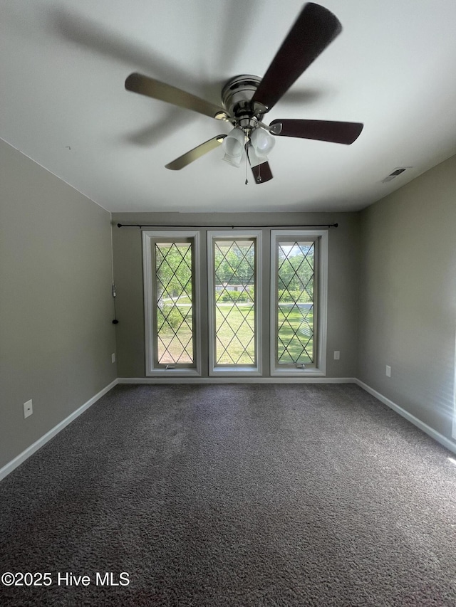 unfurnished room featuring baseboards, ceiling fan, carpet, and visible vents