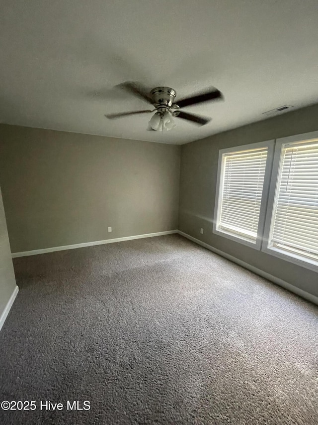 unfurnished room with baseboards, a ceiling fan, and carpet flooring
