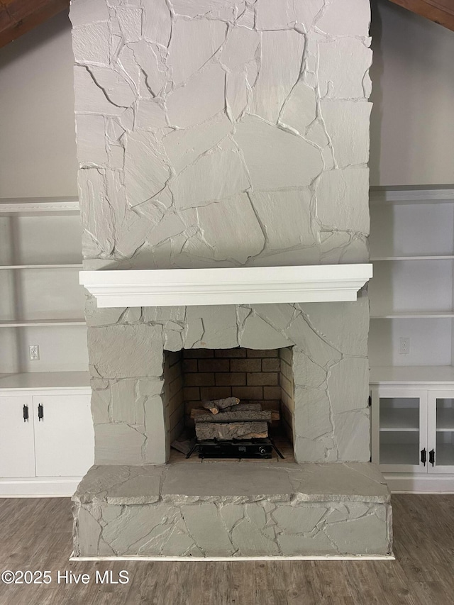 details with wood finished floors and a fireplace