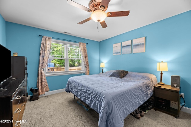 bedroom with visible vents, carpet flooring, baseboards, and a ceiling fan