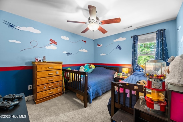 carpeted bedroom featuring ceiling fan and visible vents