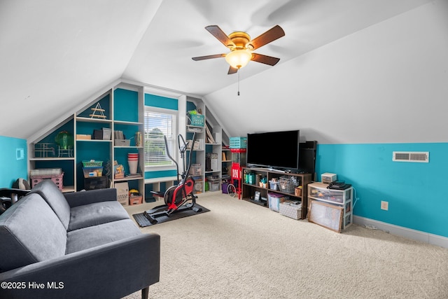 interior space featuring visible vents, carpet floors, baseboards, a ceiling fan, and vaulted ceiling