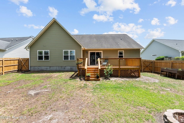 back of house featuring a lawn, a fenced backyard, a wooden deck, and crawl space