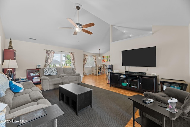 living area with ceiling fan, visible vents, wood finished floors, and lofted ceiling
