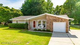 2 Cherokee Dr, Hubert, NC 28539 - view of front facade featuring concrete driveway, an attached garage, and a front lawn