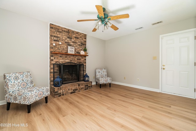 2 Cherokee Dr, Hubert, NC 28539 - unfurnished room featuring visible vents, light wood finished floors, ceiling fan, and a fireplace
