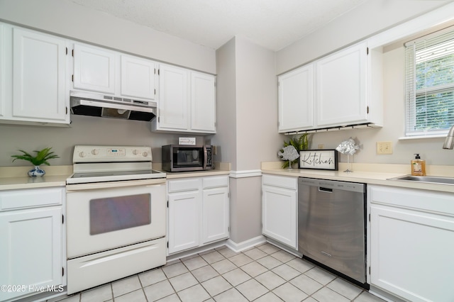 2 Cherokee Dr, Hubert, NC 28539 - kitchen with light countertops, under cabinet range hood, white cabinets, a sink, and appliances with stainless steel finishes