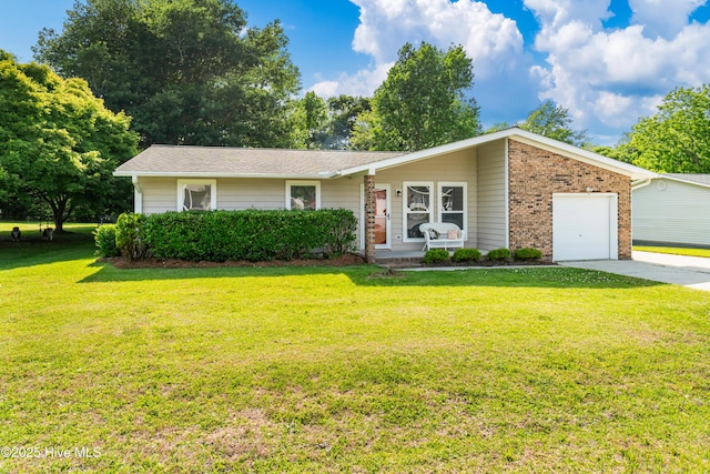 2 Cherokee Dr, Hubert, NC 28539 - view of front facade with brick siding, an attached garage, driveway, and a front yard