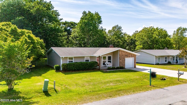 2 Cherokee Dr, Hubert, NC 28539 - ranch-style home featuring a garage, a chimney, concrete driveway, and a front yard