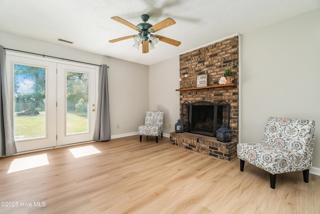 2 Cherokee Dr, Hubert, NC 28539 - living area with a fireplace, a ceiling fan, baseboards, wood finished floors, and visible vents