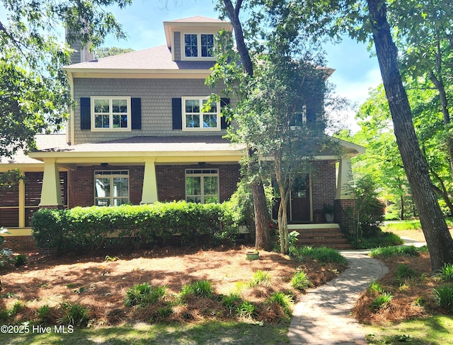 view of front of house with brick siding and a chimney