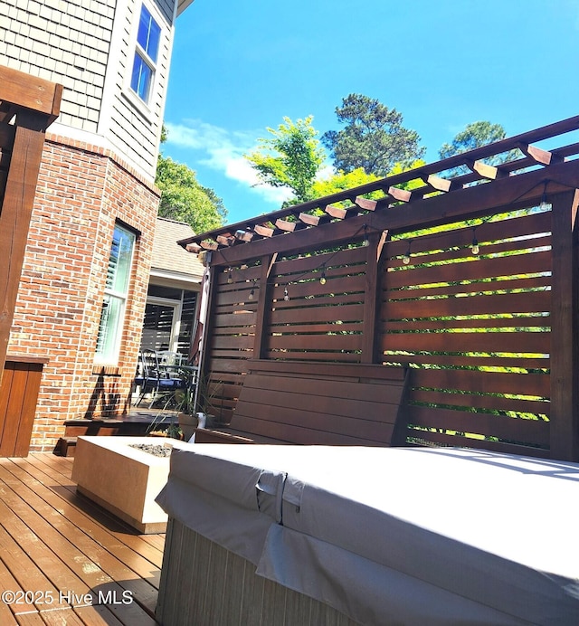 deck featuring a hot tub