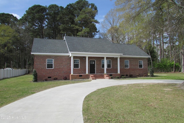 view of front facade with fence, a shingled roof, a front lawn, crawl space, and curved driveway