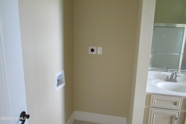 bathroom featuring baseboards and vanity